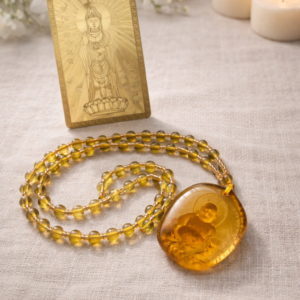 Golden wealth pendant necklace with Buddha engraving and amber-toned beads